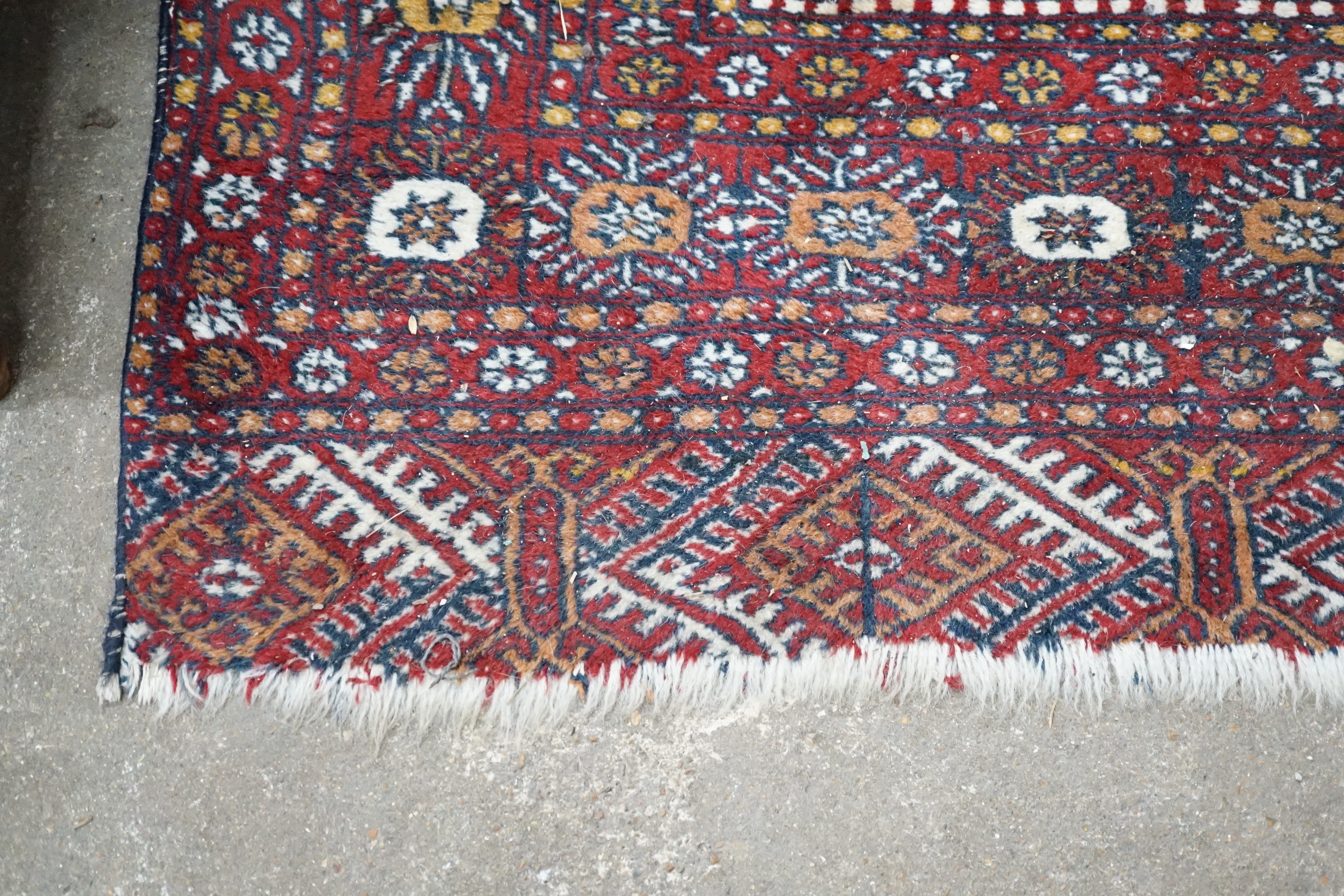 A Bokhara red ground rug, 186 x 122cm